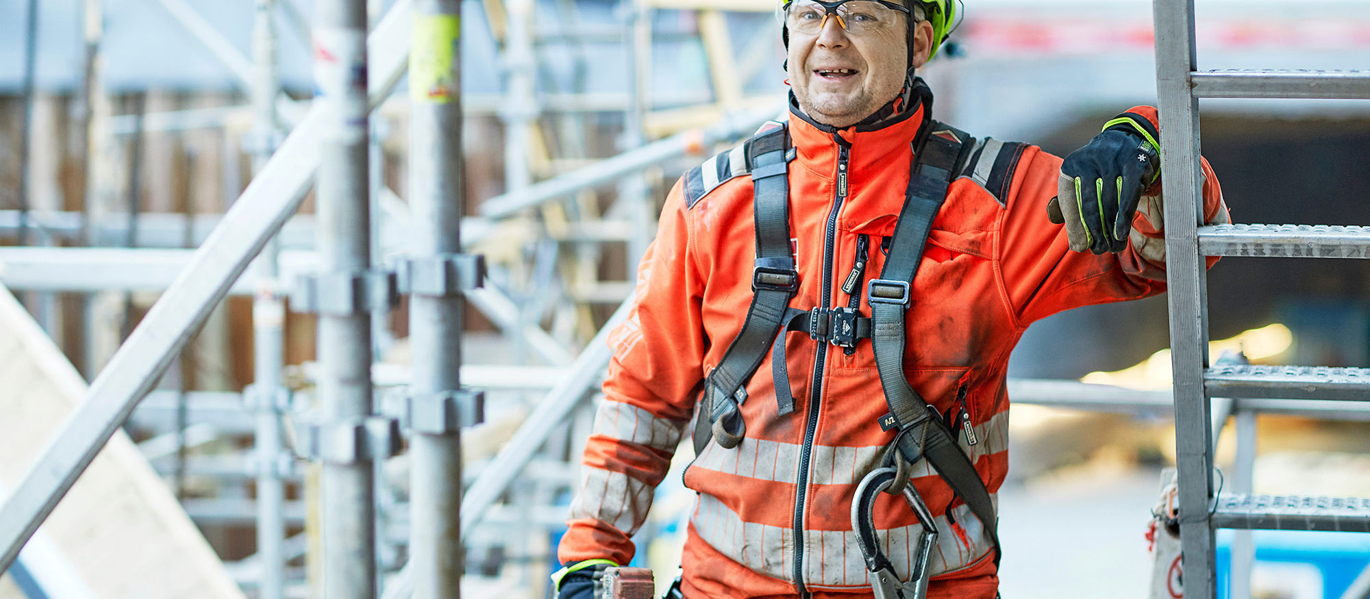 Construction worker with nail gun. Scaffold. Photo