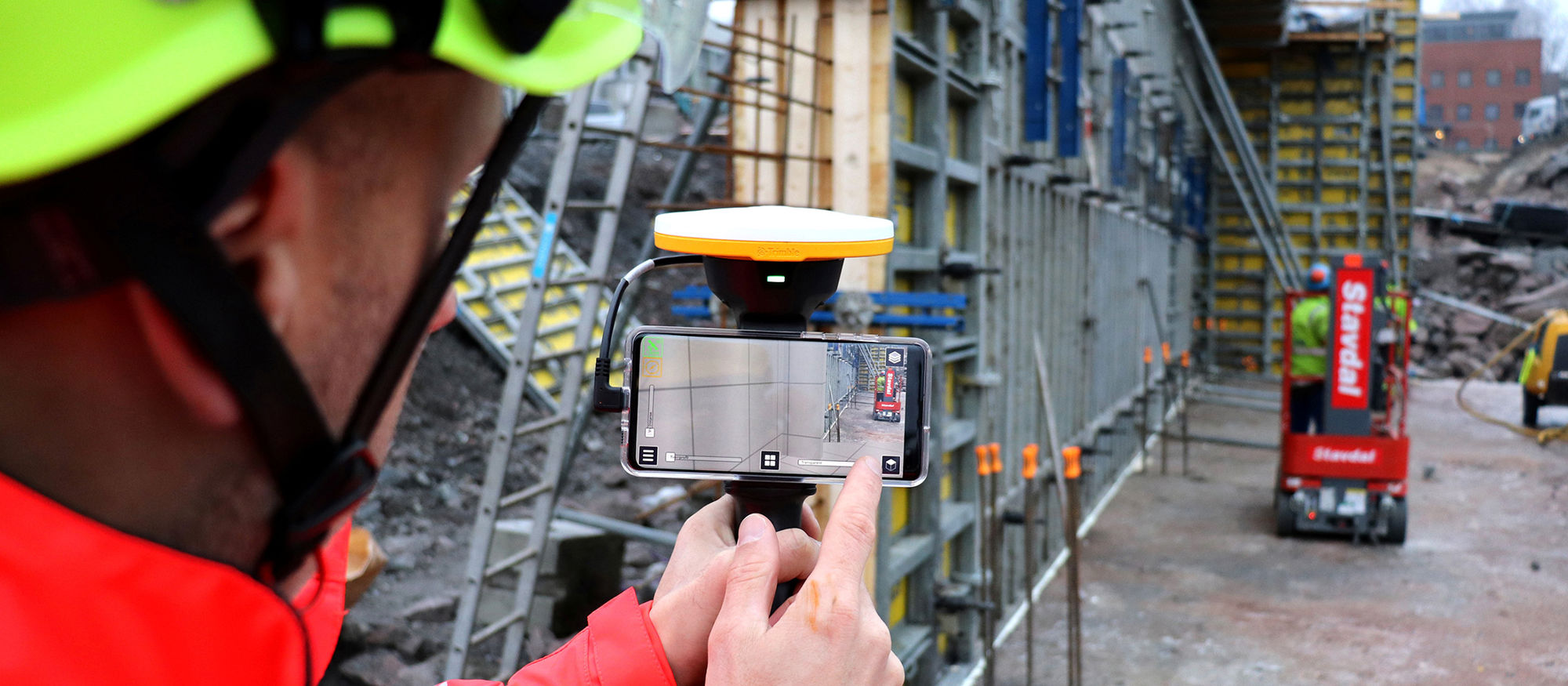 Handheld Trimble Site Vision / use of augmented reality on construction site. Photo.