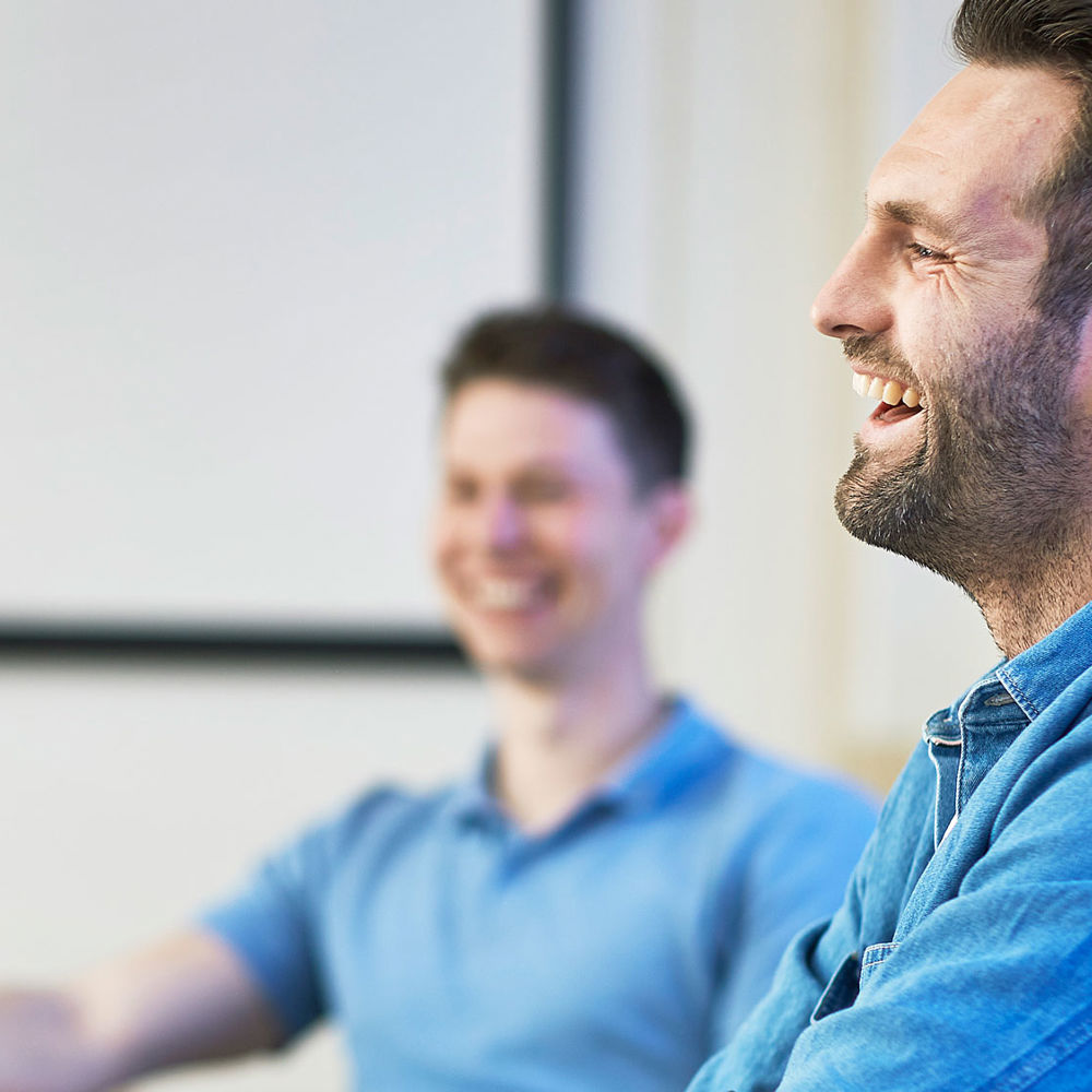 Two male students smiling and laughing. Photo.