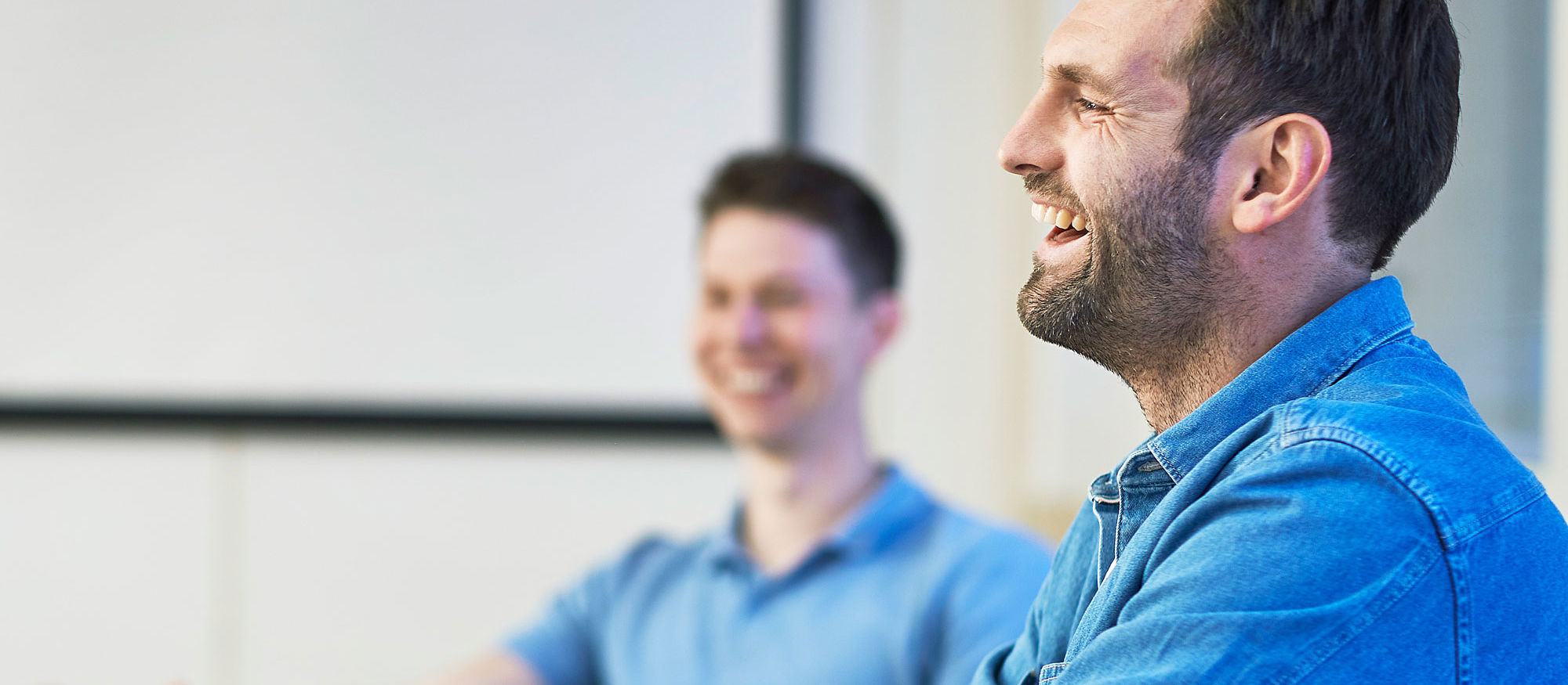 Two male students smiling and laughing. Photo.