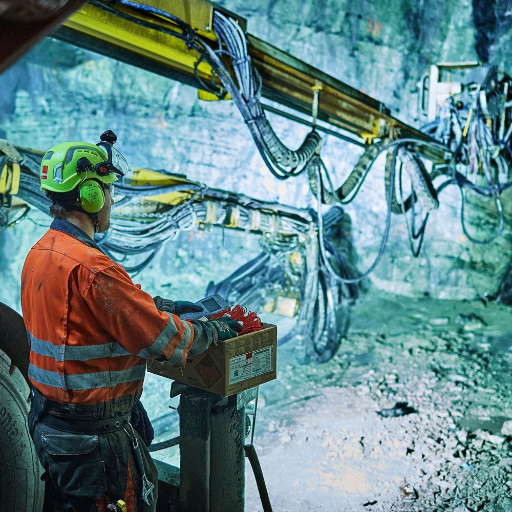 Tunnel worker with machine. Photo.